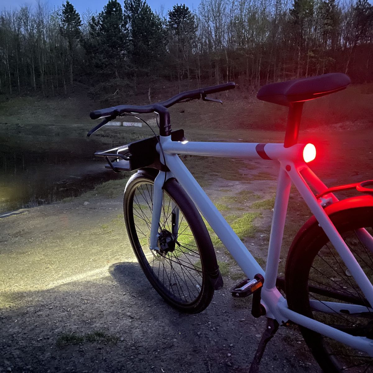 Bike with lights at lake during dusk