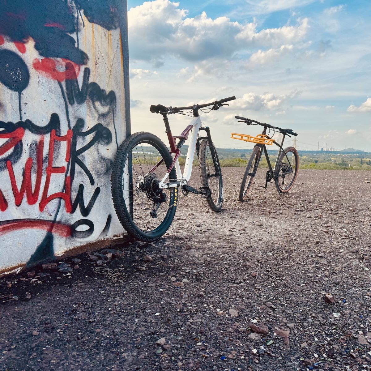 Two bikes at urban graffiti wall